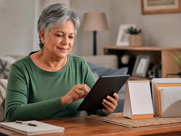 Senior person using a tablet for online health and family communication